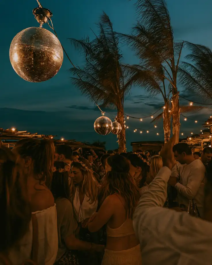 A festive table with spirits, glasses, and party lights